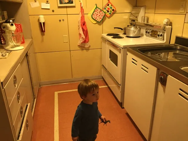 boy in the kitchen of the Lustron House