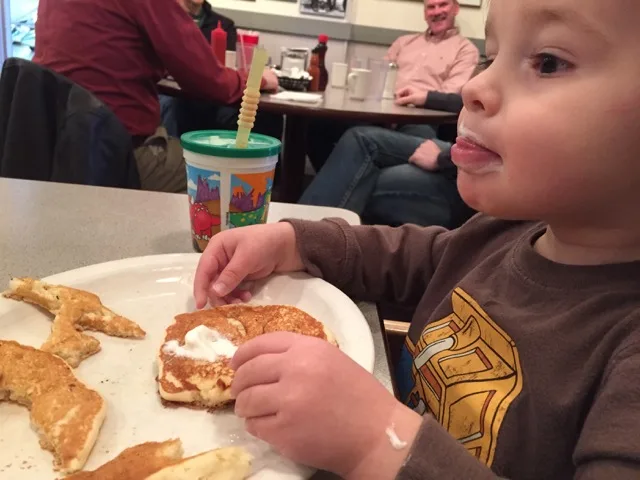 boy eating pancakes at Jack and Benny's Barnstormer Diner