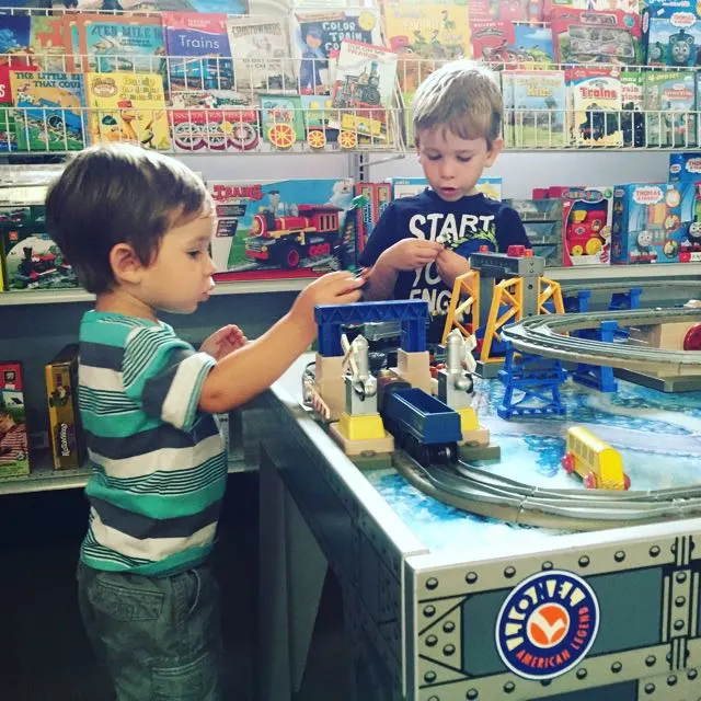 Boys playing with trains in the gift shop at Mad River and NPK Railroad Museum