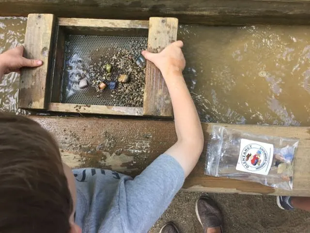 a boy mining for gems at Olentangy Indian Caverns
