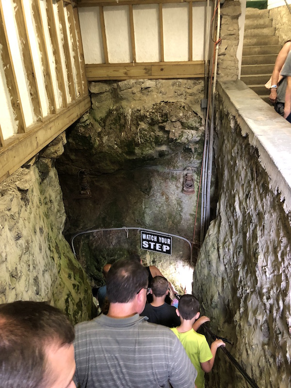 people going down the steps of Perry's Cave