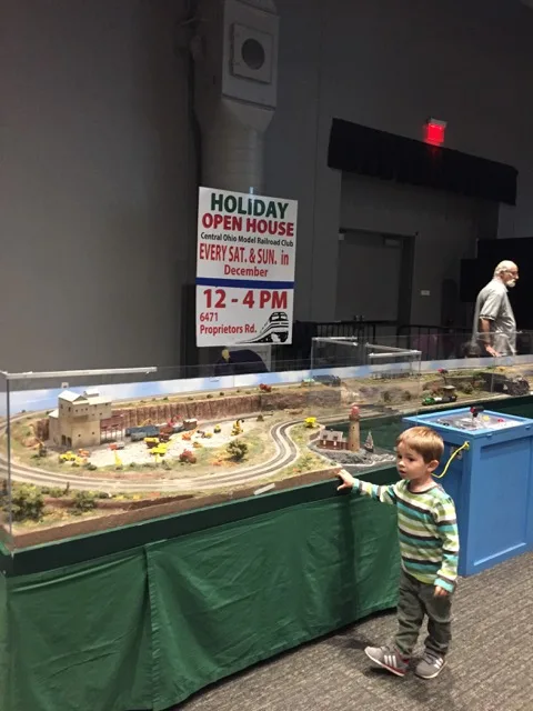 boy in front of a model railroad
