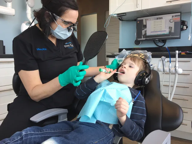 Kid brushing his teeth at River Park Dental