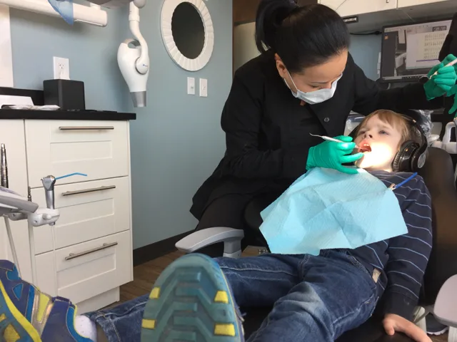 Dentist checking kid's teeth at River Park Dental