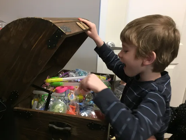 Kid picking from treasure box at River Park Dental