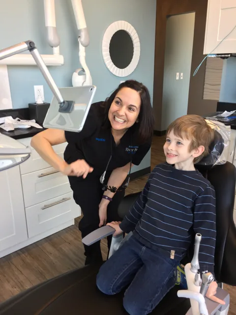 kid in dental chair at River Park Dental