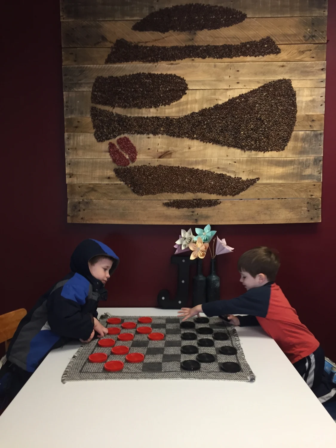 boys playing checkers at Jupiter Coffee and Donuts