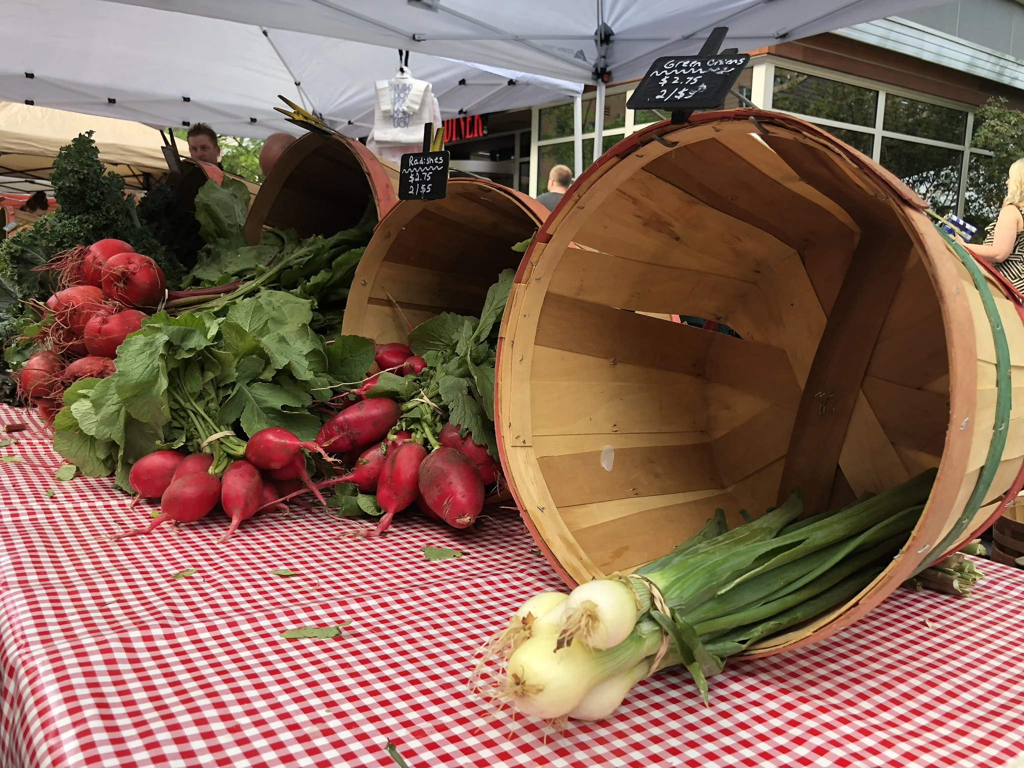 radishes and onions at a farmers market in columbus ohio