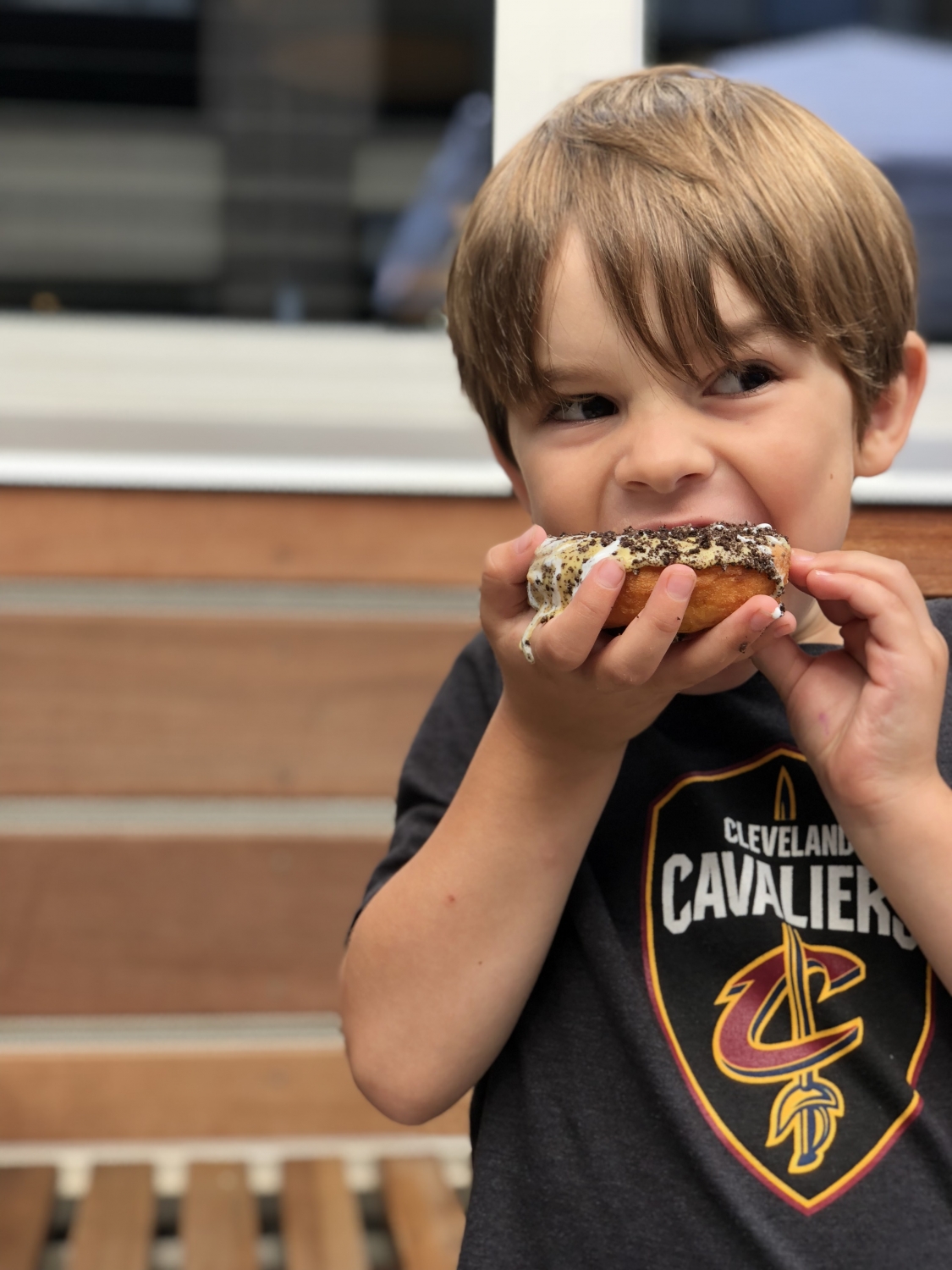 boy eating a donut at the dublin market 