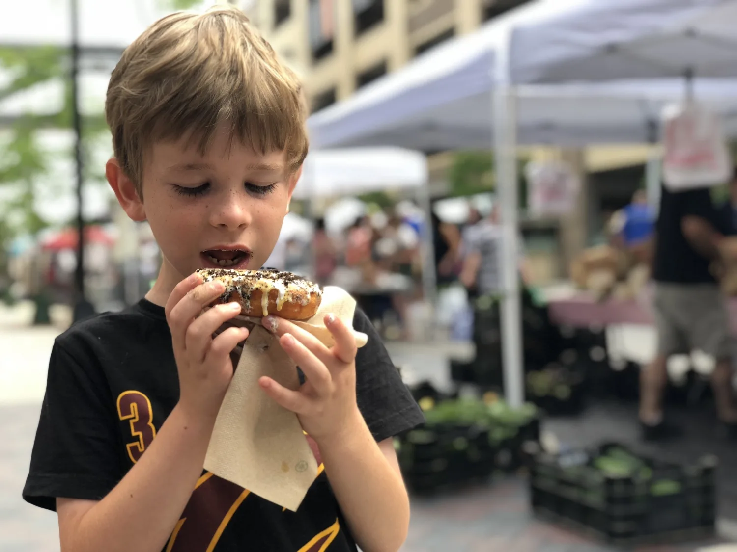 boy eating donut at the dublin market