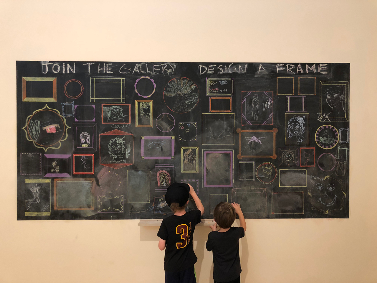 Boys drawing on chalkboard at Springfield Museum of Art 