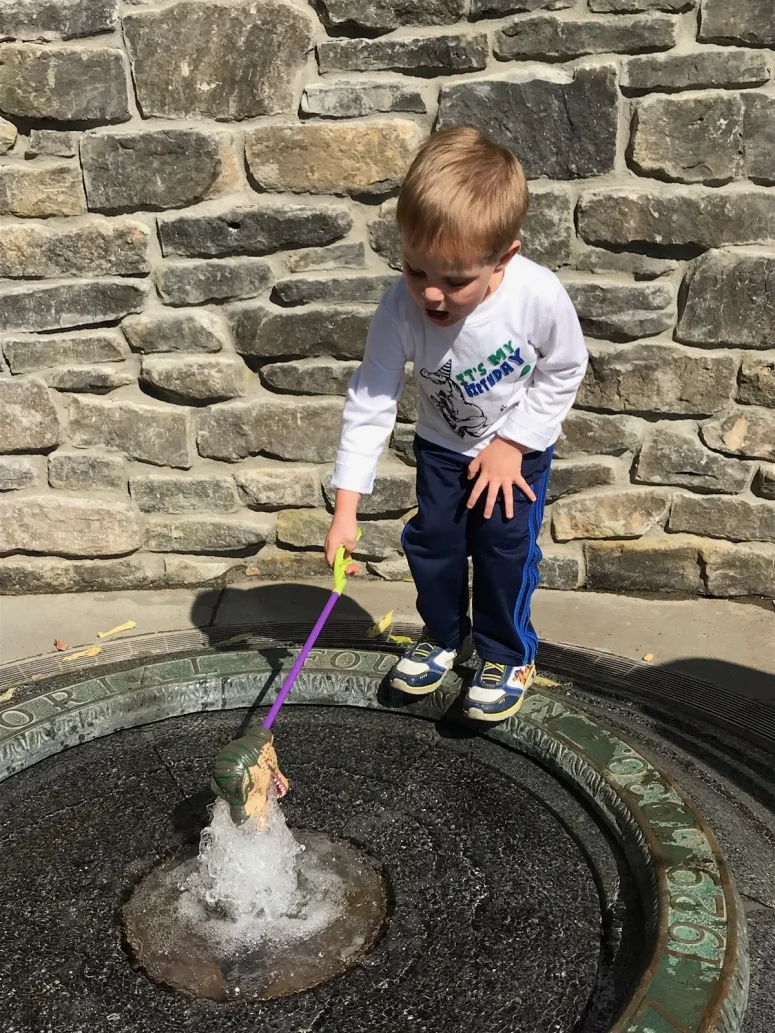 kid playing in fountain at Mirror Lake, Ohio State University Campus