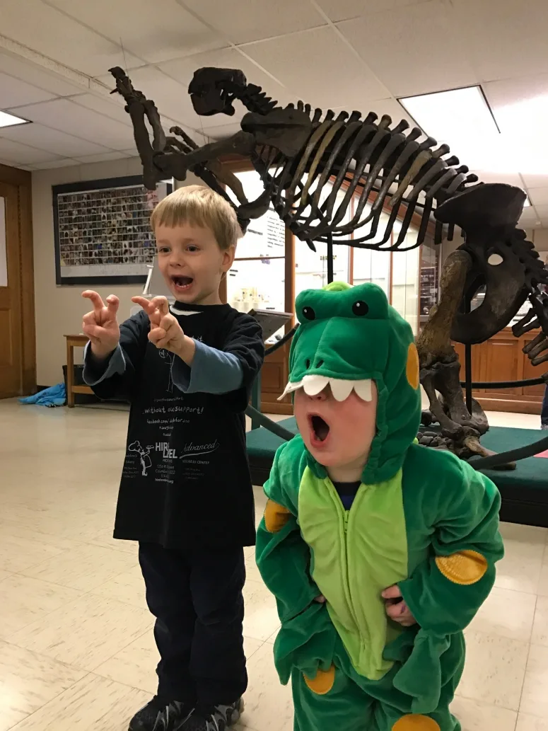kids posing in front of dinosaur at Orton Hall, Ohio State University Campus