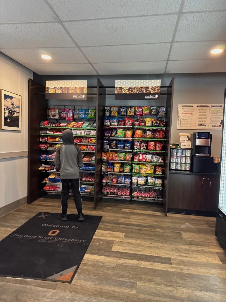 Boy looking at snacks at Market C at the OSU Airport.