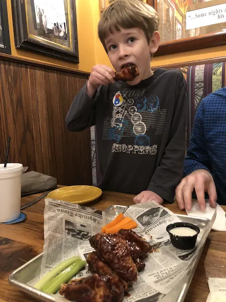 kid eating wings at Cherry Street Pub in Lancaster, Ohio
