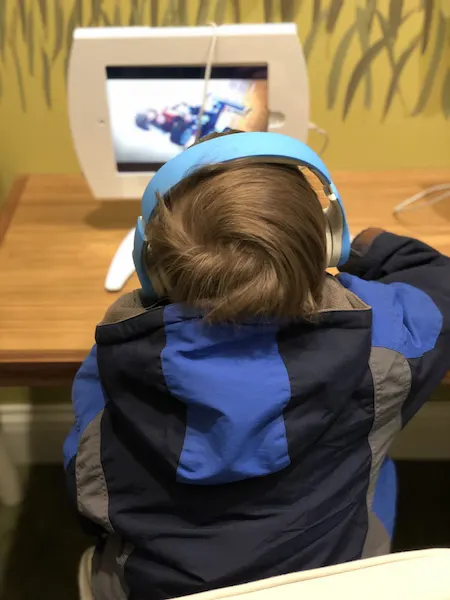 kid at iPad visiting the dentist for the first time