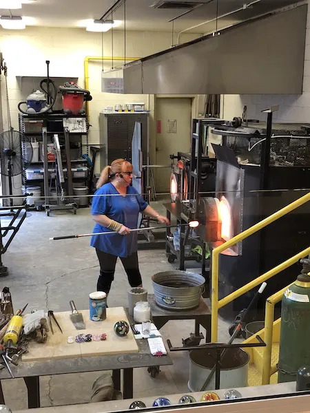 woman doing a glass blowing demonstration at Ohio Glass Museum in lancaster, Ohio