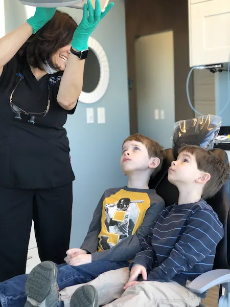 kids watching videos at first dentist visit