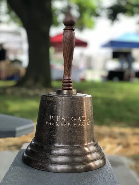 large handheld bell at the westgate farmers market in columbus ohio