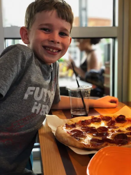kid eating pizza at Northstar Cafe Easton Town Center