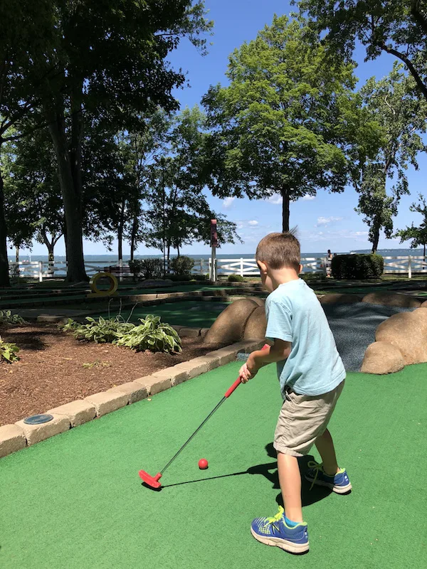 boy playing mini golf in lakeside ohio