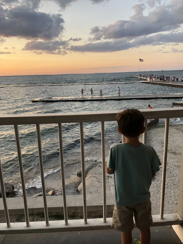 boy watching the sun set at lakeside Ohio
