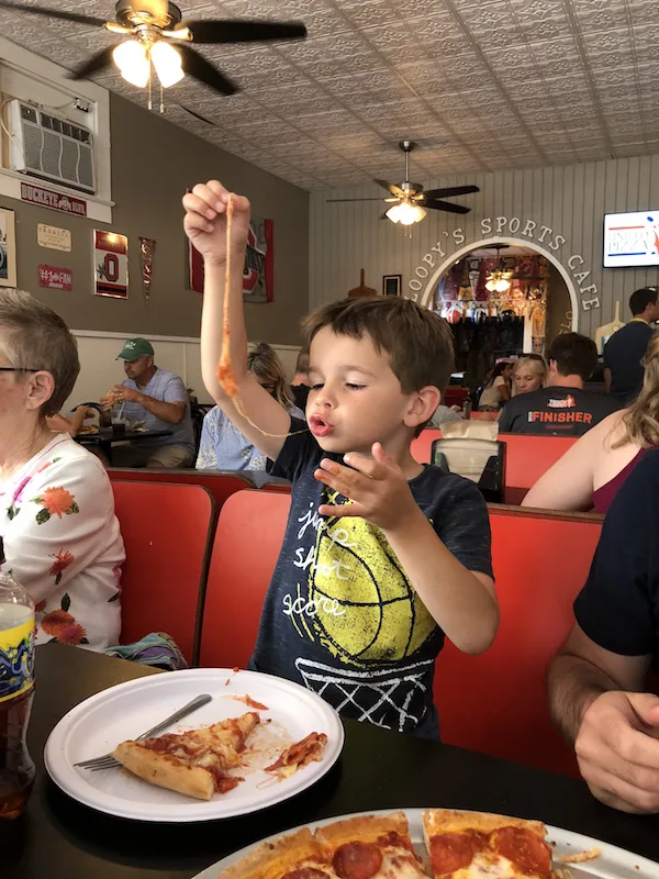 boy eating pizza at Sloopy's Cafe in Lakeside, Ohio