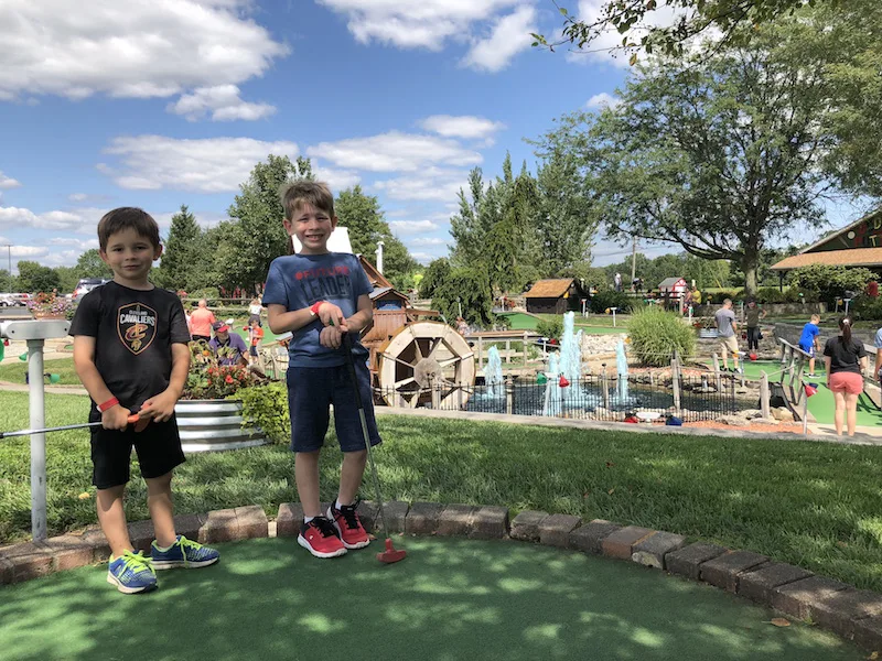 boys playing mini golf at Young's Jersey Dairy in Yellow Springs Ohio