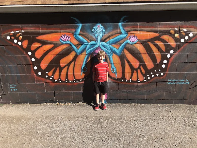 boy standing against mural in Yellow Springs, Ohio