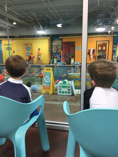 two boys sitting at Goldfish Swim School