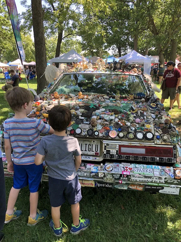 boys looking at a decorated car at Summer Jam West Festival in Westgate Park