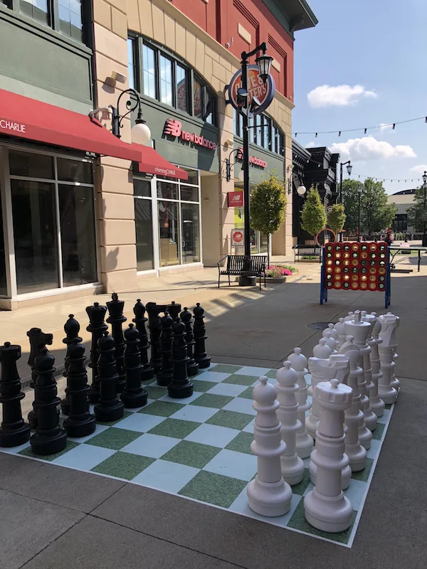 outdoor life-sized chess game at The Yard at Polaris Fashion Place