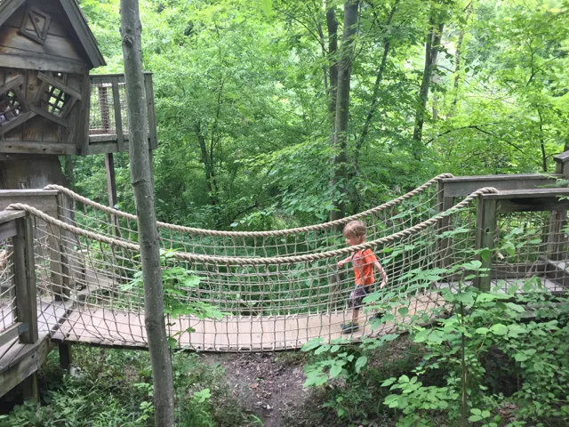 boy on wooden suspension bridge in Inniswood Metro Gardens, Columbus, Ohio