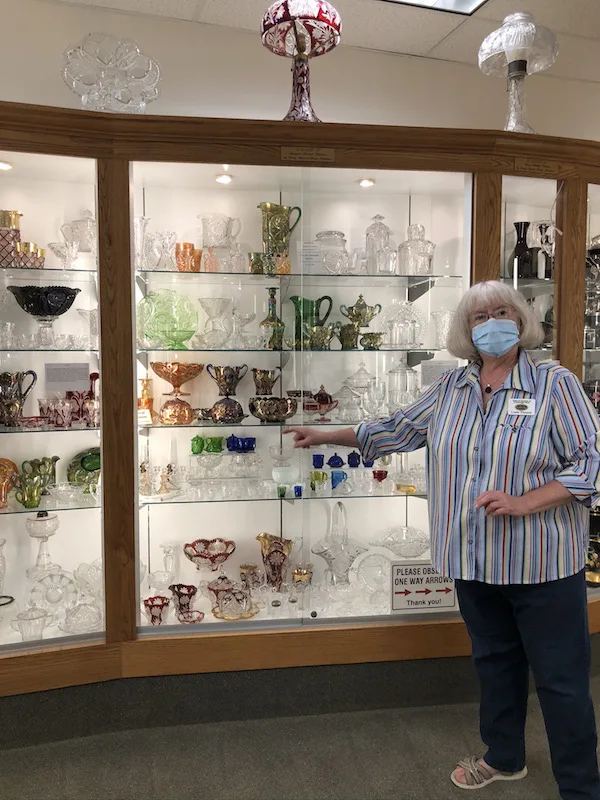 woman giving a tour at Museum of Cambridge Glass