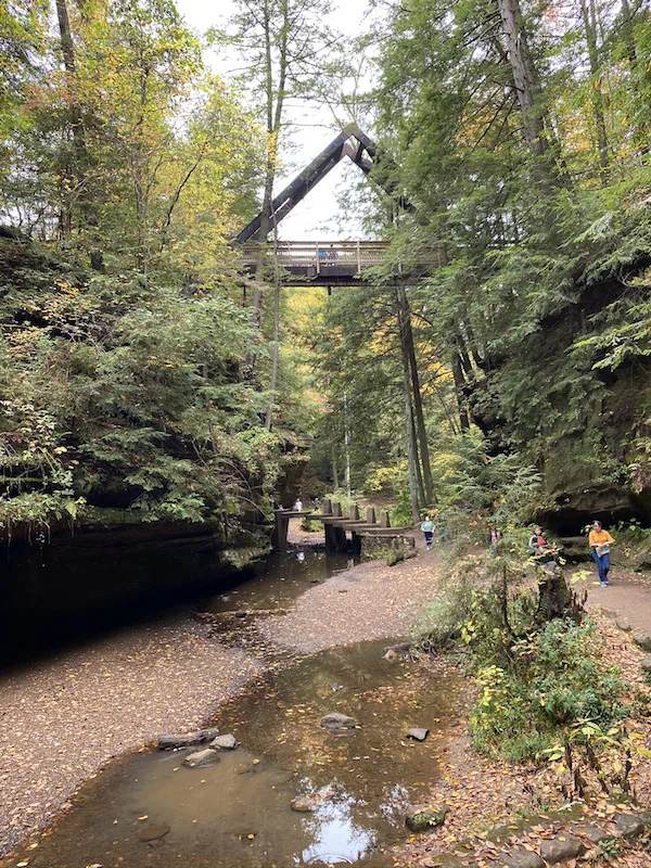 A Frame Bridge Over Gorge with people hiking underneath
