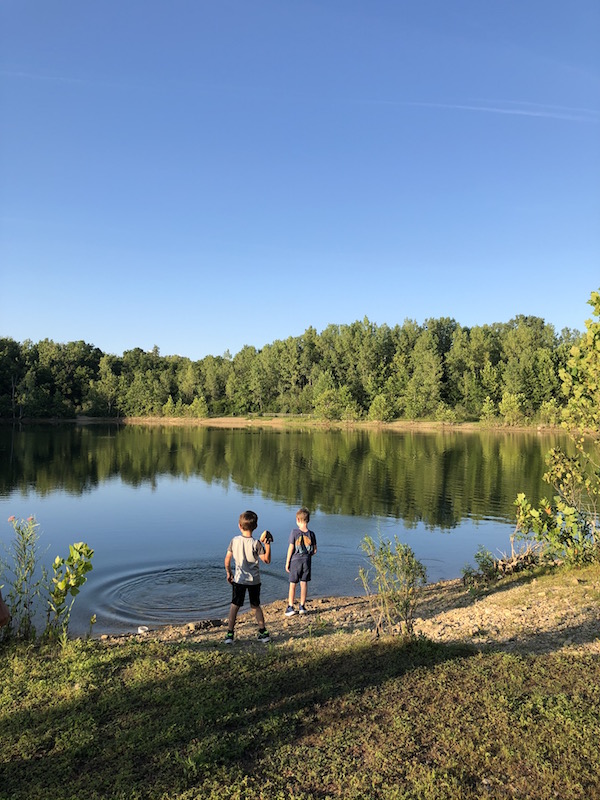 boys throwing rocks into Osprey Lake in Darbydale, Ohio