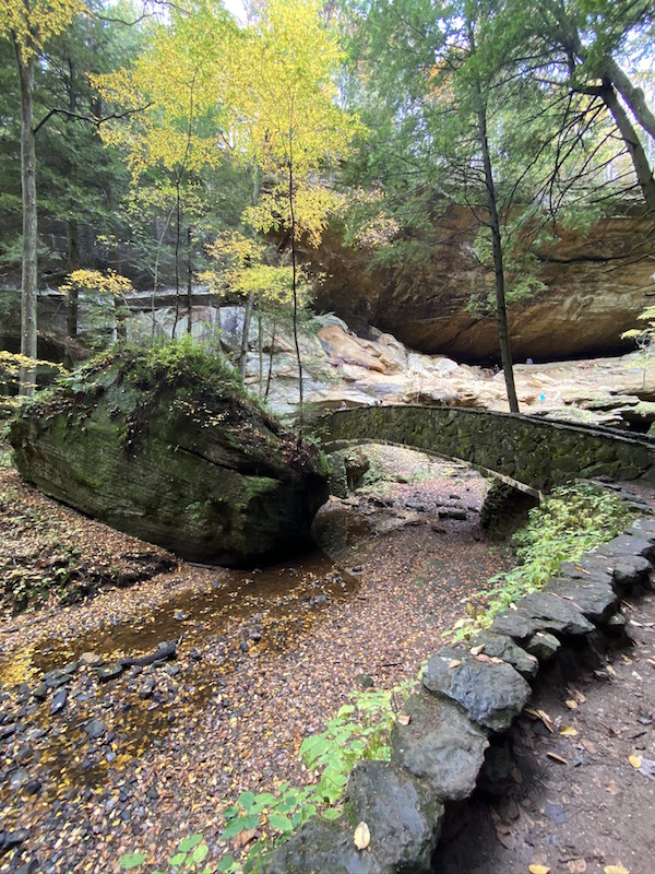 bridge made of stone with surrounded by fall leaves