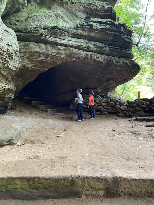 two boys heading into a cave in Hocking Hills 