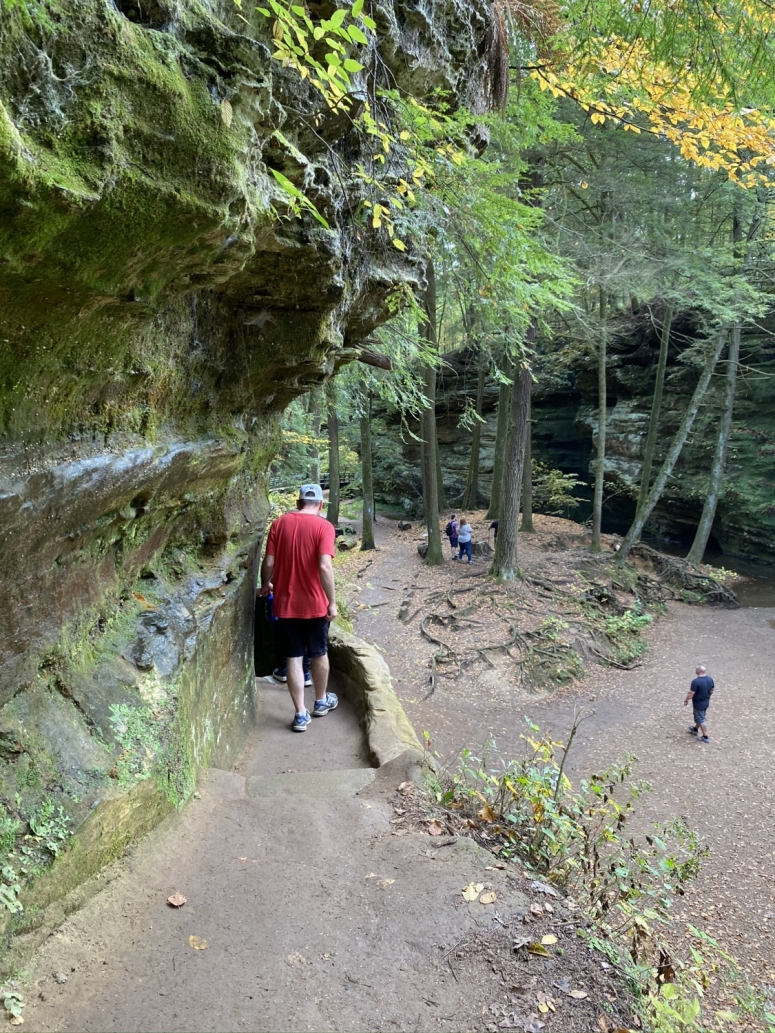 family hiking on a cliff edge in Hocking Hills, Ohio