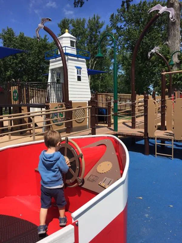 boy driving a pretend boat in Lakeview Park playground in Port Clinton, Ohio