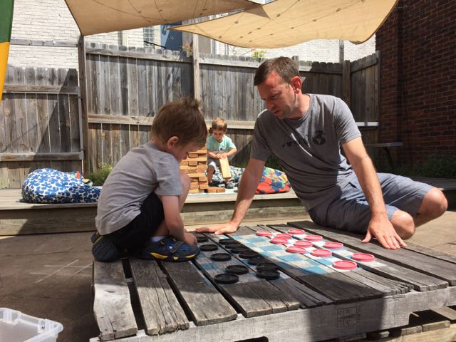 boy and dad playing checkers at Woodstock Cafe in Vermilion, Ohio