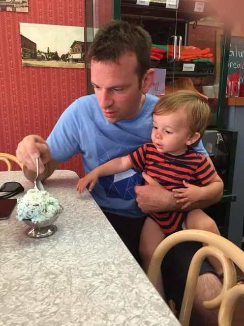 man and toddler eating ice cream at Big Ed's Soda Grill in Vermilion