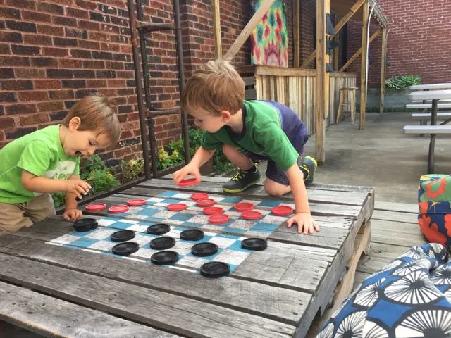 boys playing checkers at Woodstock Cafe