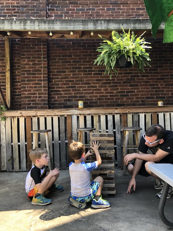 boys playing Jenga on the patio at Woodstock Cafe in Vermilion Ohio