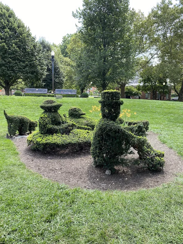 sculptures of people sitting in Topiary Park in Columbus, Ohio.