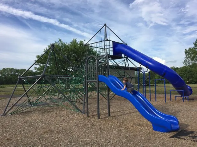 rope play structure and slides at the playground in the park.