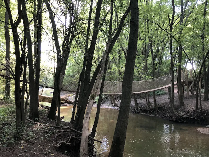 the rope bridge across the creek at scioto grove metro park.