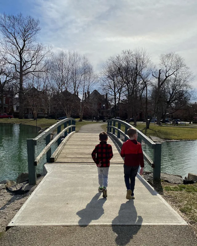 two boys walking over the bridge in Schiller Park.