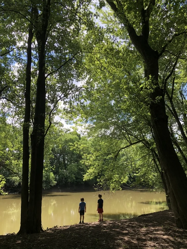 two boys standing at the edge of the Scioto River.