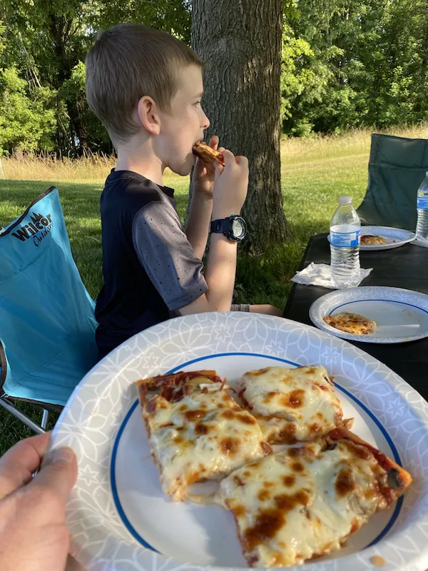 boy eating Phase Two Pizza in Perrysville Ohio.
